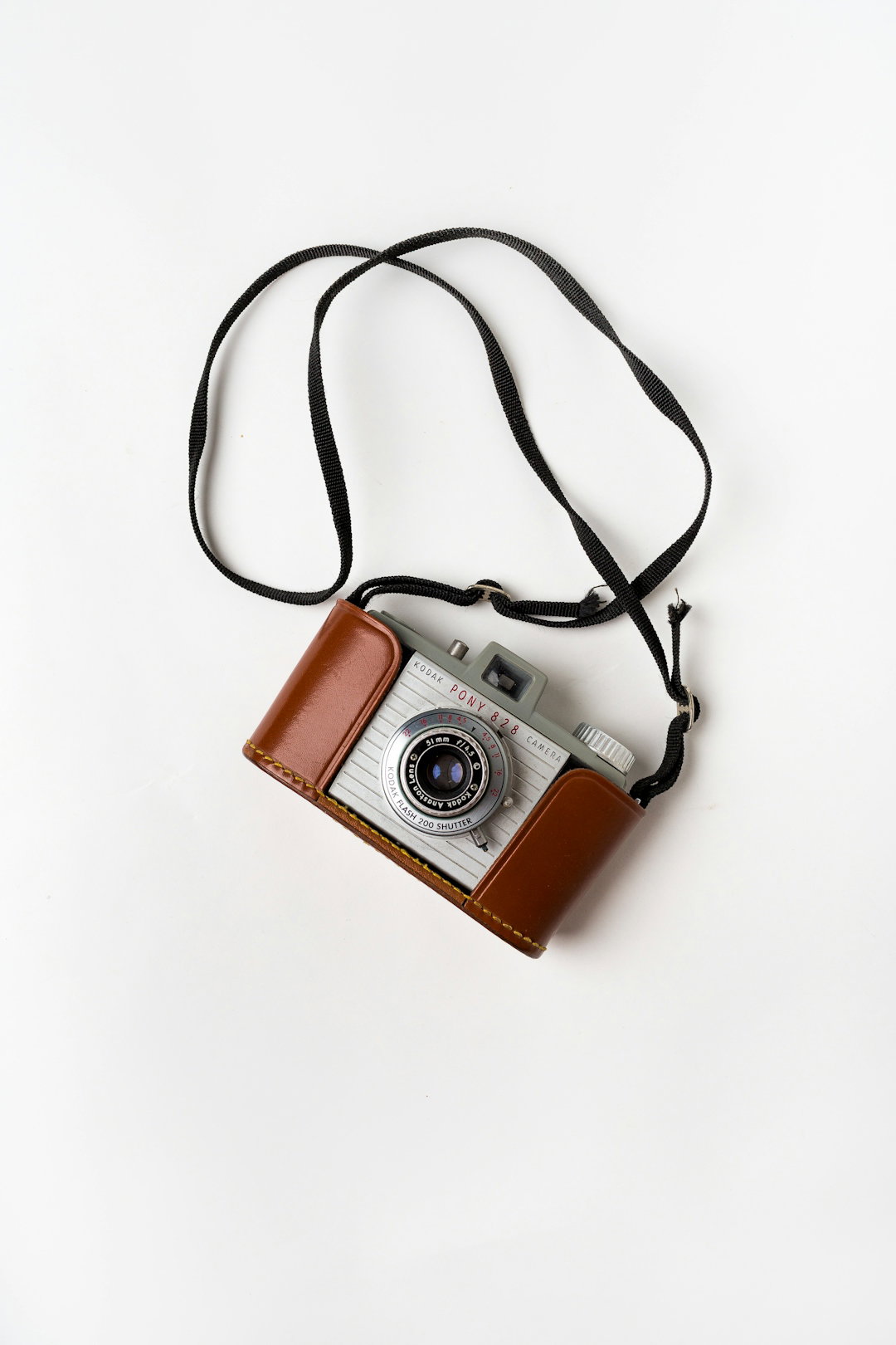brown-and-gray-slr-camera-on-white-surface.jpg brown and gray SLR camera on white surface